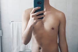 Nude boy taking a selfie