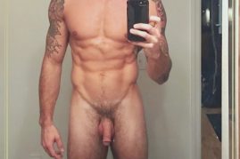 Nude man taking a selfie